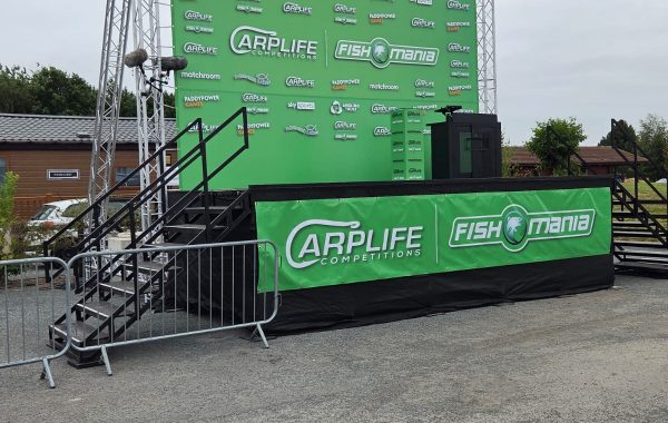 Fish O'Mania presentation stage with branding and access stairs